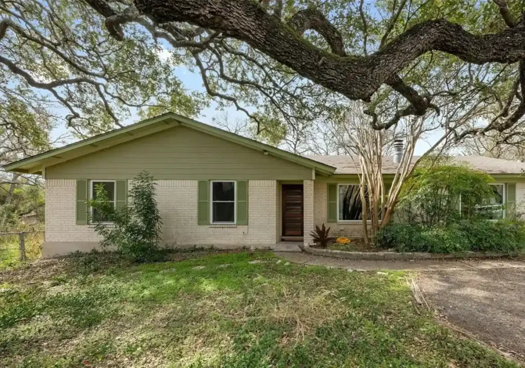 Selling Home to Cash Buyer Austin, TX Selling Home to Cash Buyer - white house in Austin, TX with green accents and large oak tree branch above.