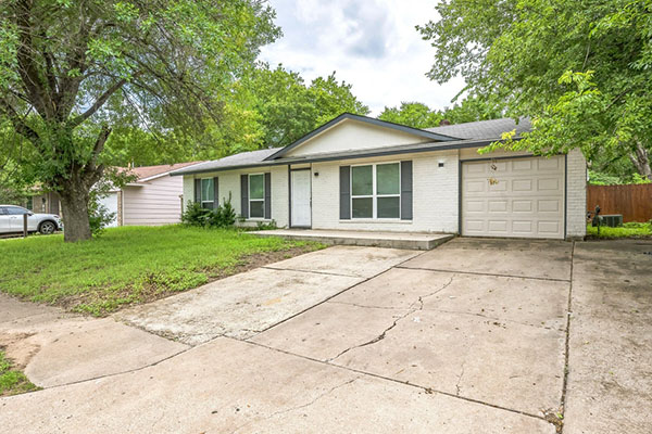 Front exterior of an older single-story Austin house sold as-is to a cash buyer without repairs