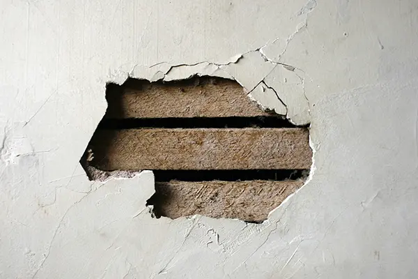 Damaged plaster wall in Austin, TX home — Austin House Buyer purchases houses in any condition, including water, fire, and structural damage.
