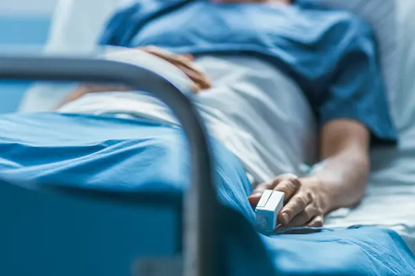 Close-up of a patient in a hospital bed representing health challenges and the need to sell a house quickly in Austin, TX.